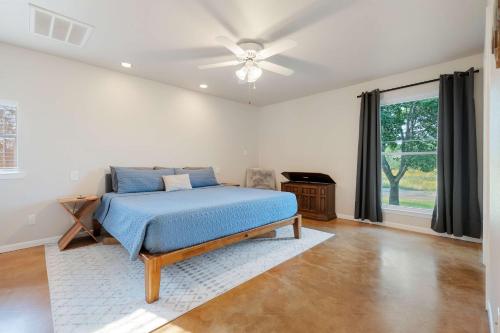 a bedroom with a bed and a ceiling fan at 2br Texas Countryside Home w Hot Tub in Marble Falls