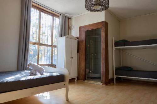 a bedroom with a bed with a stuffed animal on it at Hostal Providencia in Santiago