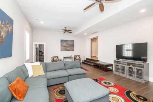 a living room with a couch and a flat screen tv at Sweet Escape in Cincinnati