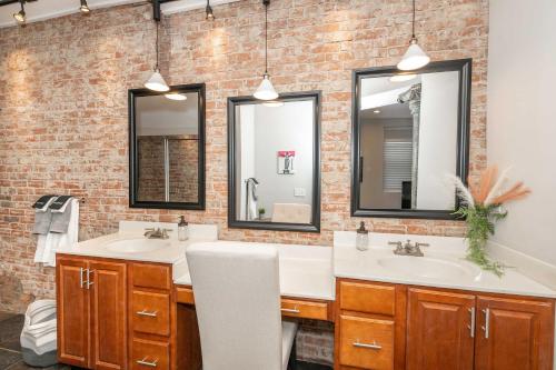 a bathroom with two sinks and two mirrors at Sweet Escape in Cincinnati