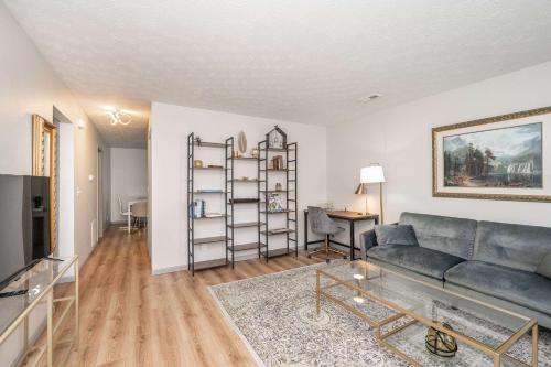 a living room with a couch and a table at Arkstone Retreat 1 - Chic Downtown Escape in Williamstown