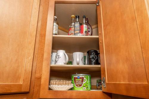 a cupboard filled with lots of bottles and drinks at Cozy Home Away From Home in Florence