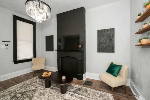 a living room with a fireplace and a tv at Stylish Modern Gem in the HIlls in Cincinnati