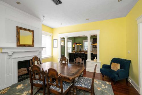 a dining room with a table and a fireplace at Westside Wanderlust with Hot Tub in Cincinnati