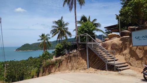 a staircase on the side of a hill next to the ocean at Ozone Hill Panoramic Residence Thong Nai Pan Beach in Thong Nai Pan Noi