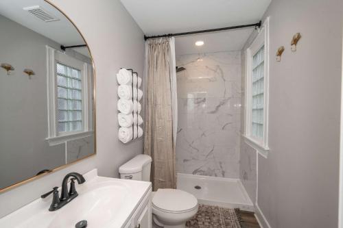 a bathroom with a sink and a toilet and a shower at LUXE Spot Suites in Covington