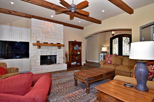 a living room with a couch and a fireplace at Pet-Friendly Oasis in Gated Community in Spicewood