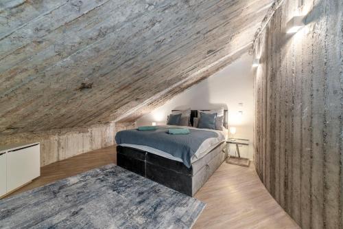 a bedroom with a bed and a wooden wall at Bunker Loft Messe Essen Self Check-in in Essen