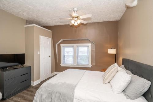 a bedroom with a white bed and a ceiling fan at Monmouth Loft 3 - Heart of Newport in Newport