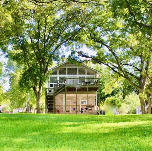a large building in the middle of a grass field at Pet Friendly Retreat on Lake LBJ in Burnet