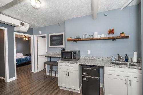 a kitchen with a sink and a microwave at Monmouth Loft 4 - Walk to Shops in Newport