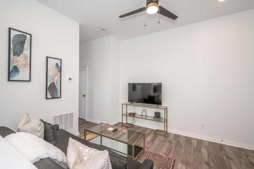 a living room with a couch and a tv at Covington Charm 201 in Covington