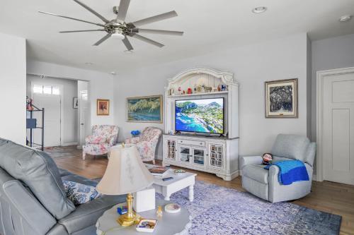 a living room with a couch and a tv at Villages at Five Points Serenity - Beach in Lewes
