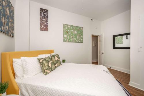 a bedroom with a large bed with white sheets at The Heart of Madison 3 in Covington