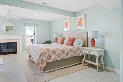 a bedroom with a bed and a fireplace at Hidden Paradise - Coastal Views in Ocean View