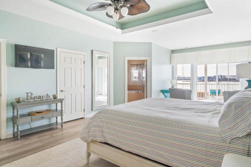 a bedroom with a bed and a ceiling fan at Hidden Paradise - Coastal Views in Ocean View