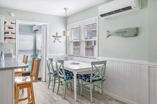 a kitchen and dining room with a table and chairs at Coastal Condo - Close to Beach & Entertainment in Rehoboth Beach