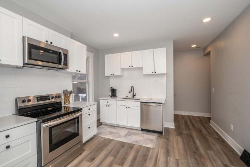a kitchen with white cabinets and stainless steel appliances at LUXE Spot 2 in Covington