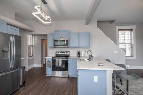 a kitchen with blue cabinets and a counter top at Heart of Mainstrasse 4 in Covington