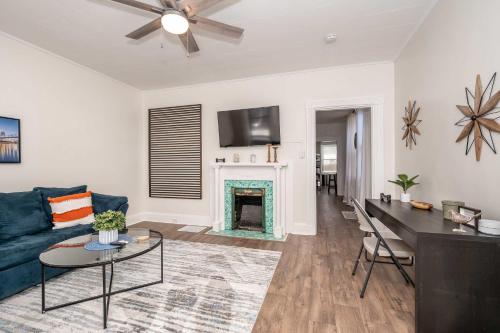 a living room with a blue couch and a fireplace at Historic Ludlow Apt A in Ludlow