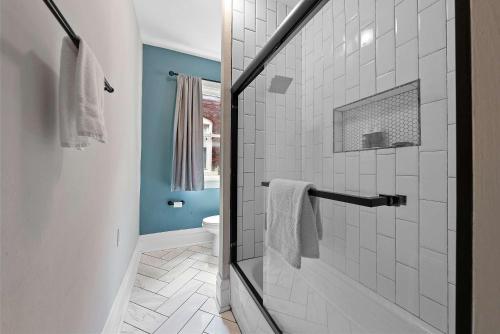 a bathroom with a shower with a glass door at Merion Village Residences - Peaceful Columbus Neighborhood in Columbus
