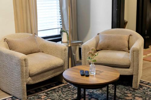 two chairs and a coffee table in a living room at Merion Village Residences 1166 in Columbus