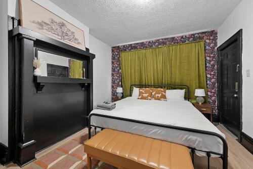a bedroom with a bed and a green curtain at Merion Village Residences 1166 in Columbus