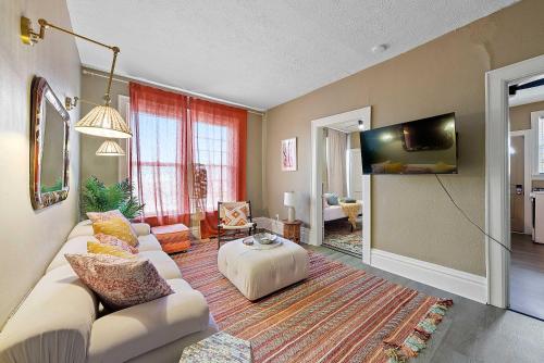 a living room with a white couch and a table at Merion Village Residences - Escape the Hustle & Bustle in Columbus