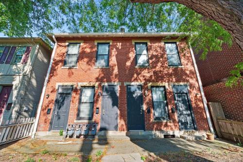 an old red brick house with a blue door at The Luxe Pearl Residences in Columbus