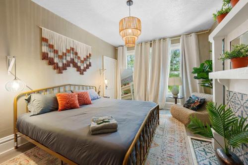 a bedroom with a bed and a large window at Merion Village Residences - Escape the Hustle & Bustle in Columbus