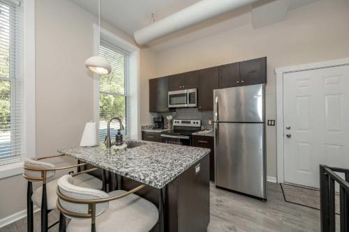 a kitchen with a stainless steel refrigerator and a counter at Queen City Views 2 Sleeps 2 in Cincinnati