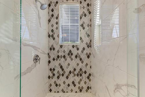 a bathroom with a shower with a glass door at Immaculate Waterfront Family Home for 16 w Private Dock in Kingsland