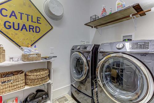 a washing machine in a laundry room with a sign at Immaculate Waterfront Family Home for 16 w Private Dock in Kingsland