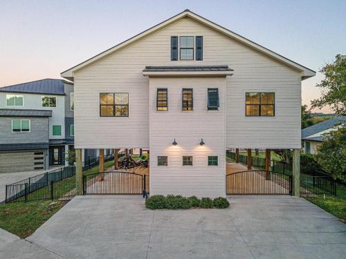 a large white house with a driveway at Immaculate Waterfront Family Home for 16 w Private Dock in Kingsland