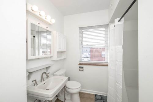 a white bathroom with a toilet and a sink at The Grand Elm Suite 1 - Sleeps 4 in Ludlow