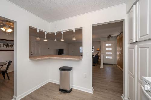 a living room with white walls and a trash can at The Grand Elm Suite 2 in Ludlow