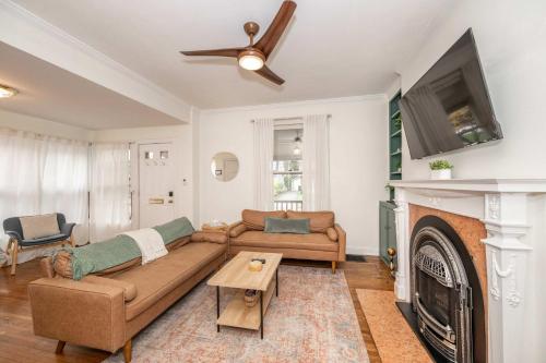 a living room with a couch and a fireplace at Clintonville Charm in Columbus