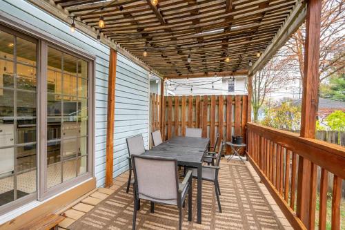 a patio with a table and chairs on a deck at Clintonville Charm in Columbus