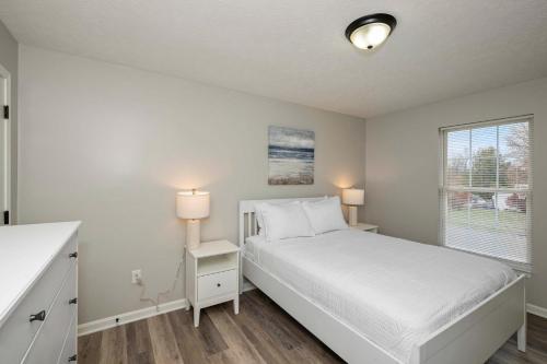 a bedroom with a white bed and a window at The Restful Ark in Crittenden