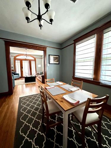 a dining room with a wooden table and chairs at Mid City 2 BR- beautiful, renovated Arts & Crafts Flat in New Orleans