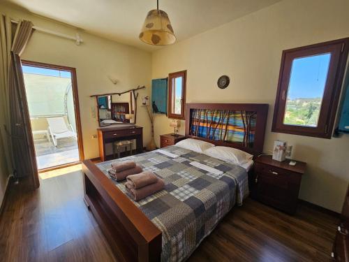 a bedroom with a bed with towels on it at Villa Agapi in Pitsidia