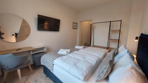 a hotel room with a bed and a desk and a desk at Hotel Kutzbach in Reuterstadt Stavenhagen