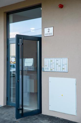 an entrance to a building with a glass door at Apartman Sunset Doboj in Doboj
