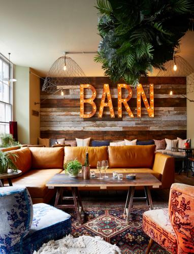 a bar with a couch and a table in a room at Artist Residence Cornwall in Penzance