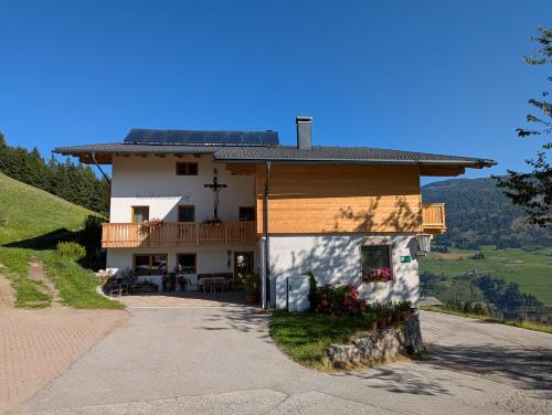 a house with a cross on the side of it at Neuhauserhof in Kartitsch