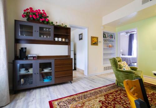 a living room with a cabinet with flowers on it at Mariposa Buckeye - Retreat for 2 in Kerrville