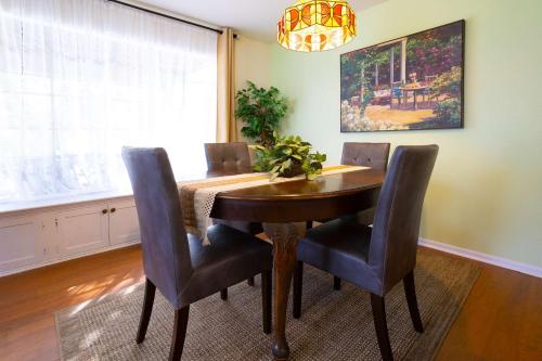 a dining room with a wooden table and chairs at Mariposa Monarch - Walk to River in Kerrville