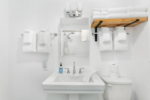 a bathroom with a sink and a toilet and towels at Breakwater Resort in Grayland