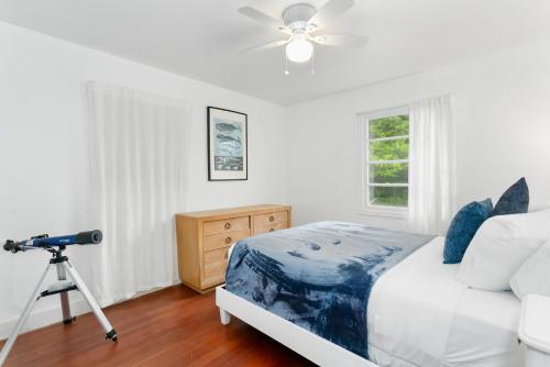 a bedroom with a camera on a tripod next to a bed at Breakwater Resort in Grayland