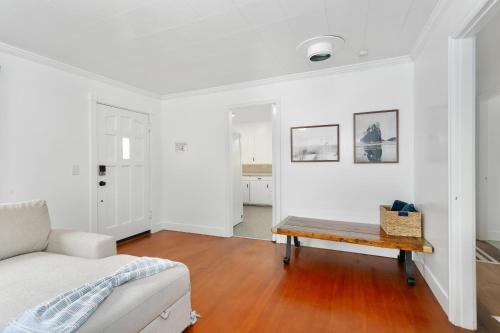 a white living room with a couch and a table at Breakwater Resort in Grayland